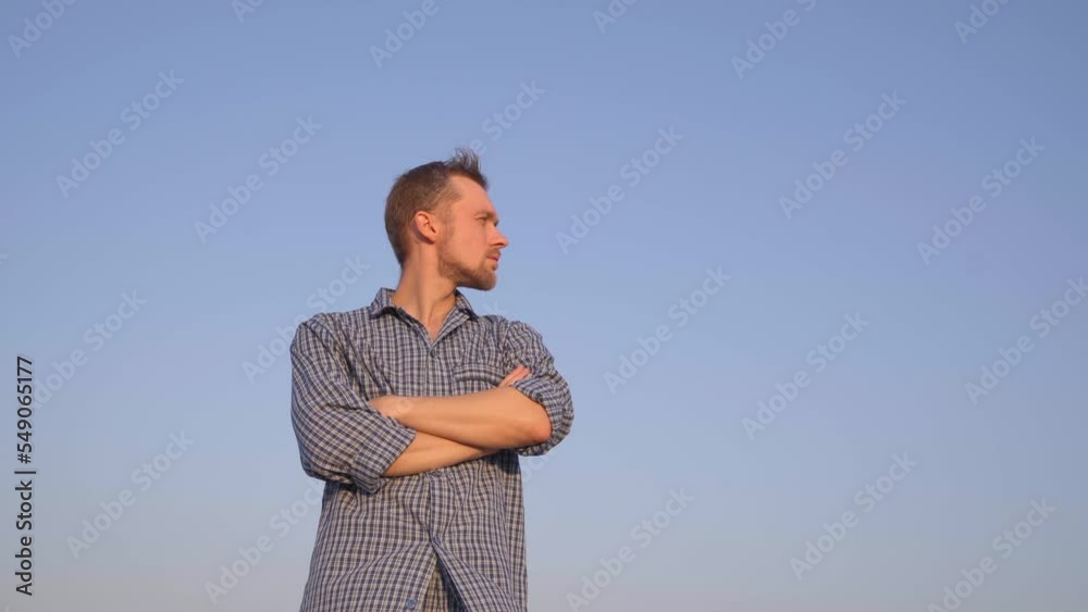 Cheerful bearded caucasian male standing outdoor wearing pyjamas looking at side. Relaxing morning or chillout concept. Clear blue sky at background. High quality 4k footage Cheerful bearded caucasian male standing outdoor wearing pyjamas looking at side. Relaxing morning or chillout concept. Clear blue sky at background. High quality 4k footage