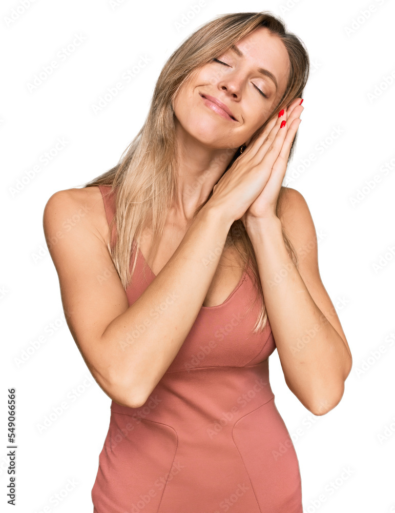 Beautiful caucasian woman wearing casual clothes sleeping tired dreaming and posing with hands together while smiling with closed eyes. Beautiful caucasian woman wearing casual clothes sleeping tired dreaming and posing with hands together while smiling with closed eyes.