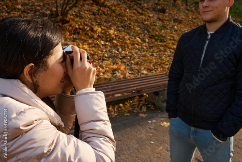 Beautiful long-haired woman takes a picture of her friend