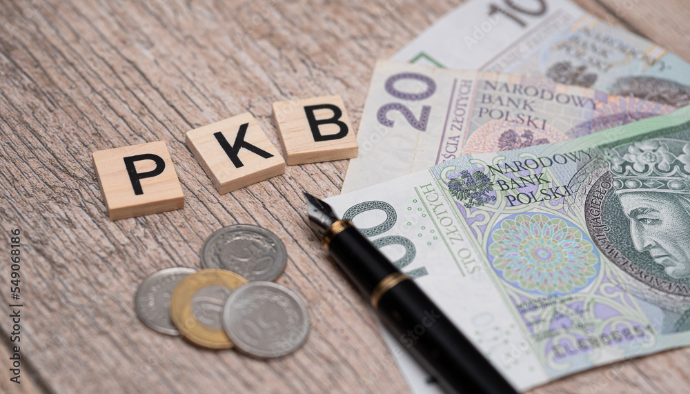 Inscription PKB which is Gross Domestic product in Polish next to polish zloty. Concept showing economic growth in Poland Inscription PKB which is Gross Domestic product in Polish next to polish zloty. Concept showing economic growth in Poland