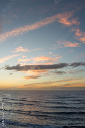 Pink and golden clouds in blue sky, sunset over the sea. Bajamar, Tenerife, Canary Islands. 