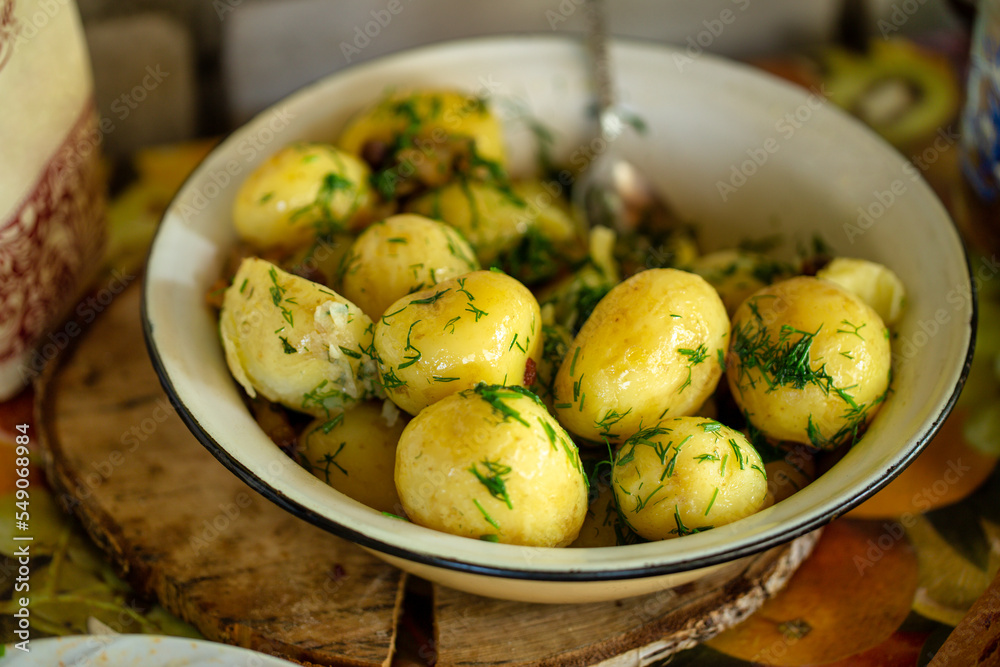 Fresh boiled new potatoes with fresh dill on rustic background Fresh boiled new potatoes with fresh dill on rustic background