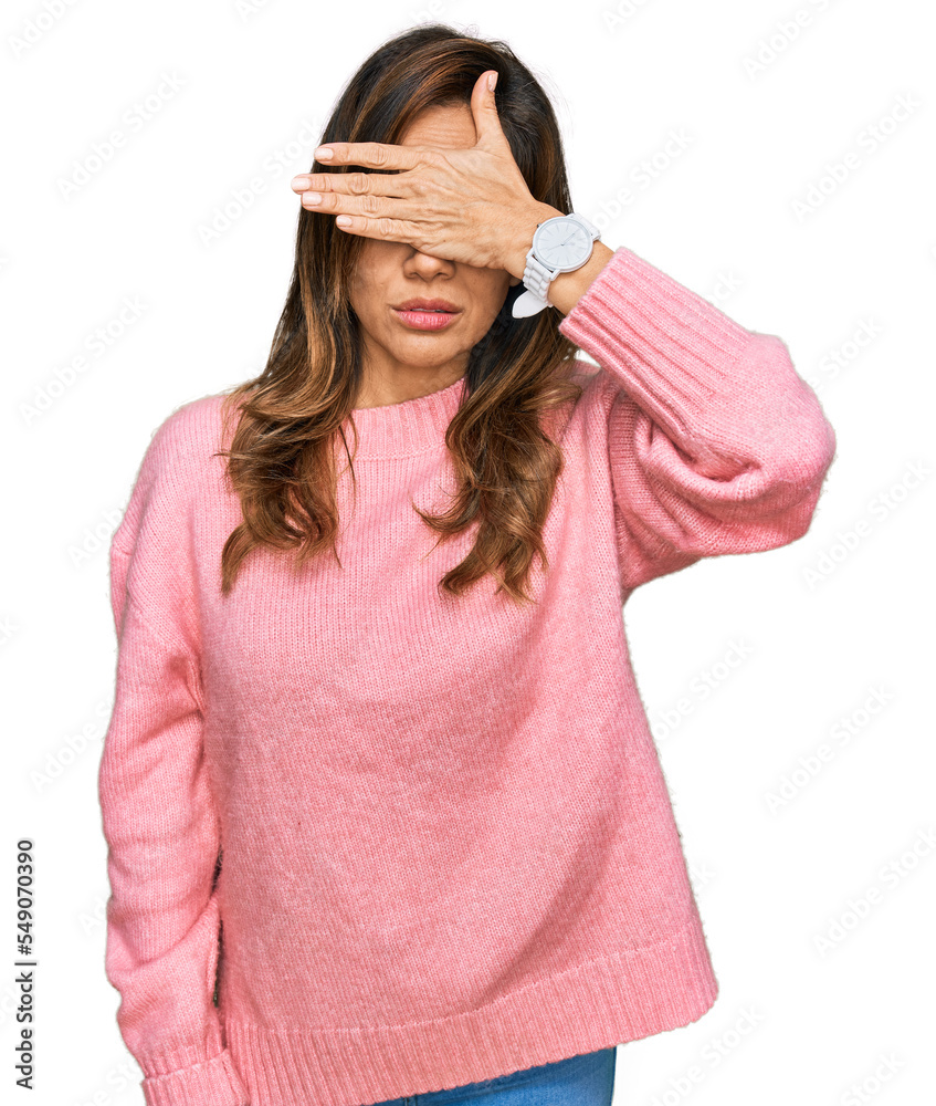 Young hispanic woman wearing casual clothes covering eyes with hand, looking serious and sad. sightless, hiding and rejection concept Young hispanic woman wearing casual clothes covering eyes with hand, looking serious and sad. sightless, hiding and rejection concept