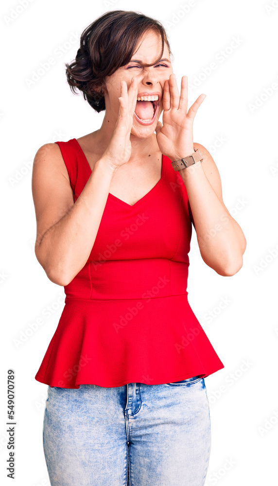 Beautiful young woman with short hair wearing casual style with sleeveless shirt shouting angry out loud with hands over mouth Beautiful young woman with short hair wearing casual style with sleeveless shirt shouting angry out loud with hands over mouth