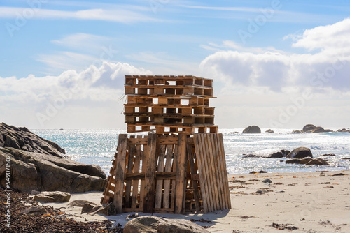 Driftwood sculpture erected of wooden pallets on the beach, Norway, Brusand photo