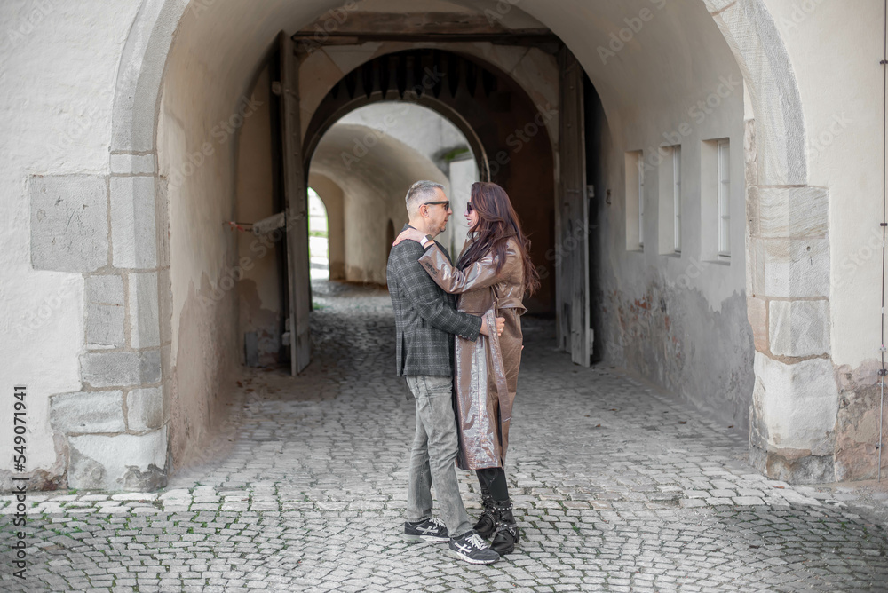 love story of a loving couple.a couple - a girl and a guy walk and hug near the arch