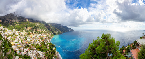 Touristic Town, Positano, on Rocky Cliffs and Mountain Landscape by the Tyrrhenian Sea. Amalfi Coast, Italy. Cloudy Sky. Panorama