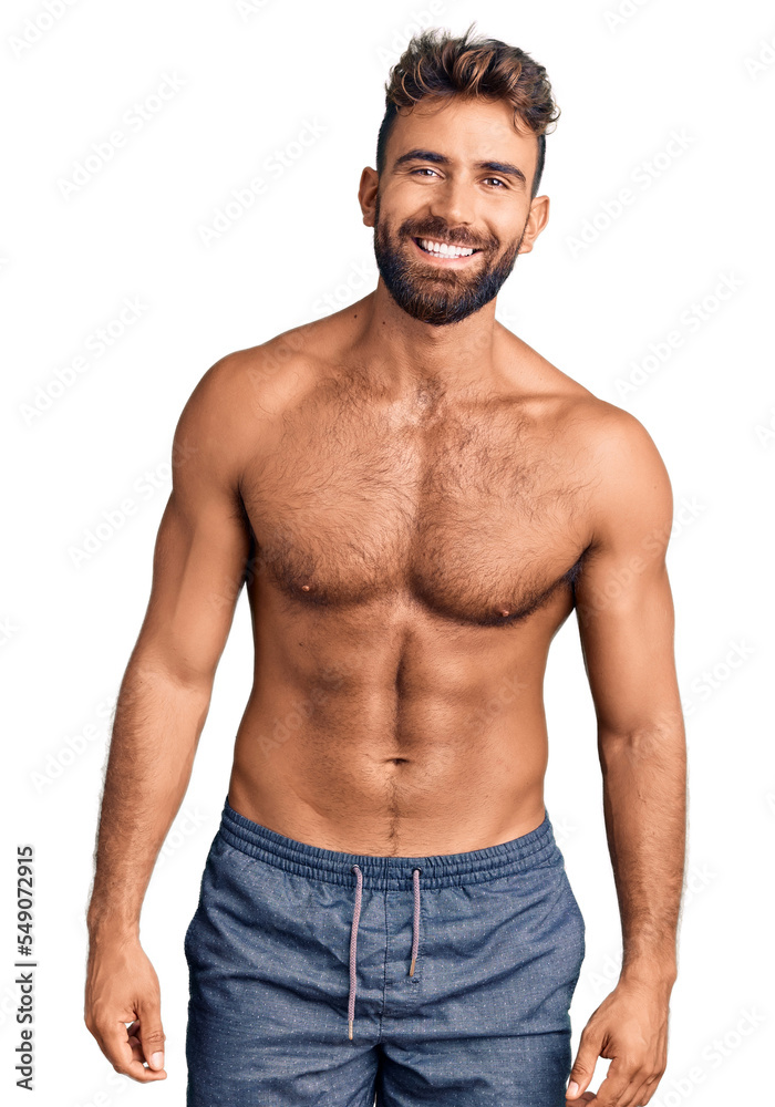 Young hispanic man wearing swimwear shirtless with a happy and cool smile on face. lucky person. Young hispanic man wearing swimwear shirtless with a happy and cool smile on face. lucky person.