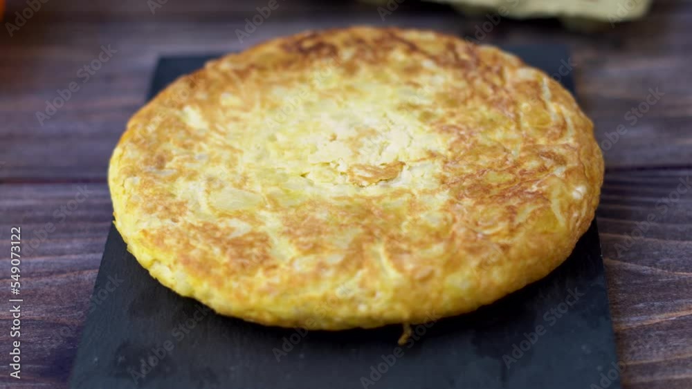 Panning from top to bottom with a close-up view of a Spanish potato omelette Panning from top to bottom with a close-up view of a Spanish potato omelette