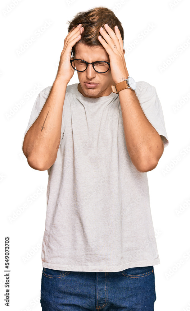 Handsome caucasian man wearing casual clothes and glasses suffering from headache desperate and stressed because pain and migraine. hands on head. Handsome caucasian man wearing casual clothes and glasses suffering from headache desperate and stressed because pain and migraine. hands on head.