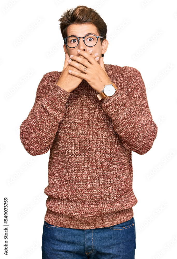 Handsome caucasian man wearing casual sweater and glasses shocked covering mouth with hands for mistake. secret concept. Handsome caucasian man wearing casual sweater and glasses shocked covering mouth with hands for mistake. secret concept.