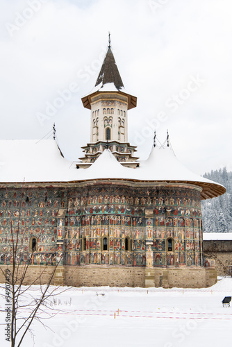 Sucevita, Romania, 2021-12-29. Sucevita Monastery in the Bukovina region under the snow. Their exterior walls are composed of frescoes painted in the 15th and 16th centuries, representing portraits of photo