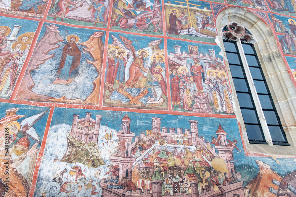 Obraz premium Moldovita, Romania, 2021-12-30. Moldovita Monastery, in the Bukovina region. Its exterior walls are composed of frescoes painted in the 15th and 16th centuries, representing portraits of saints and pr