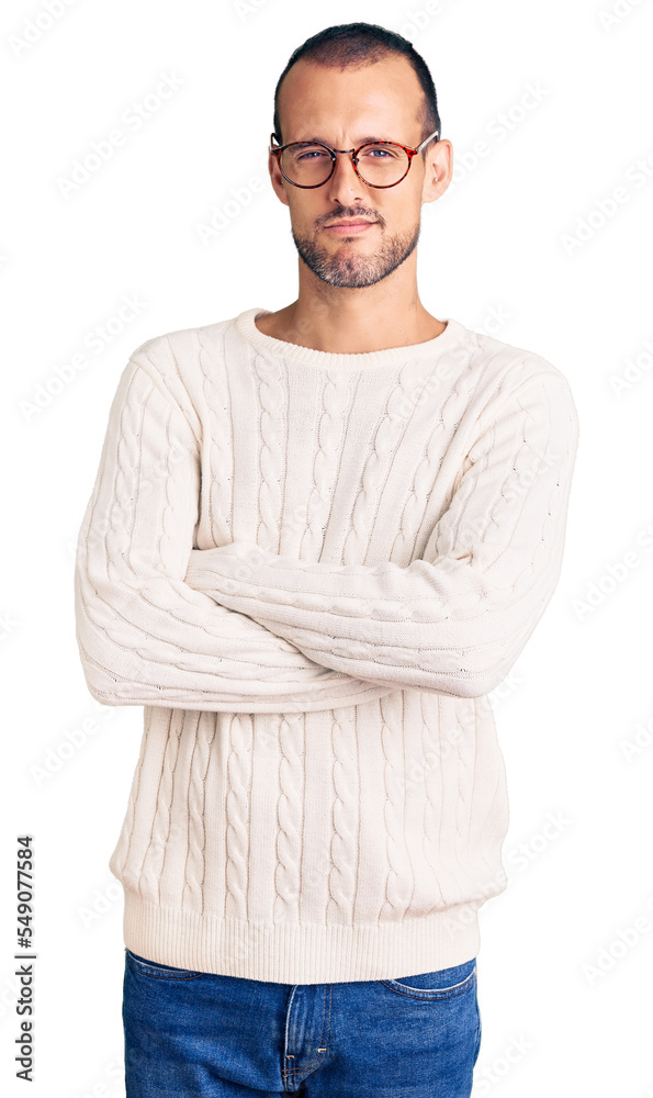 Young handsome man wearing casual clothes and glasses skeptic and nervous, disapproving expression on face with crossed arms. negative person. Young handsome man wearing casual clothes and glasses skeptic and nervous, disapproving expression on face with crossed arms. negative person.