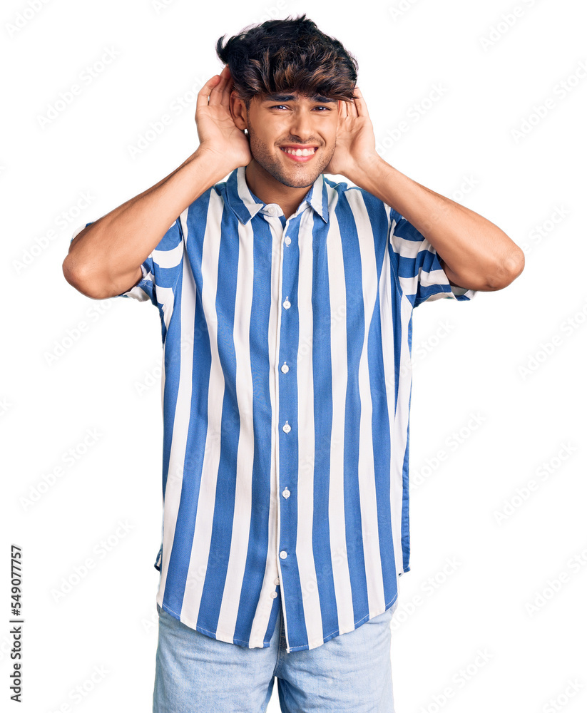 Young hispanic man wearing casual clothes trying to hear both hands on ear gesture, curious for gossip. hearing problem, deaf Young hispanic man wearing casual clothes trying to hear both hands on ear gesture, curious for gossip. hearing problem, deaf