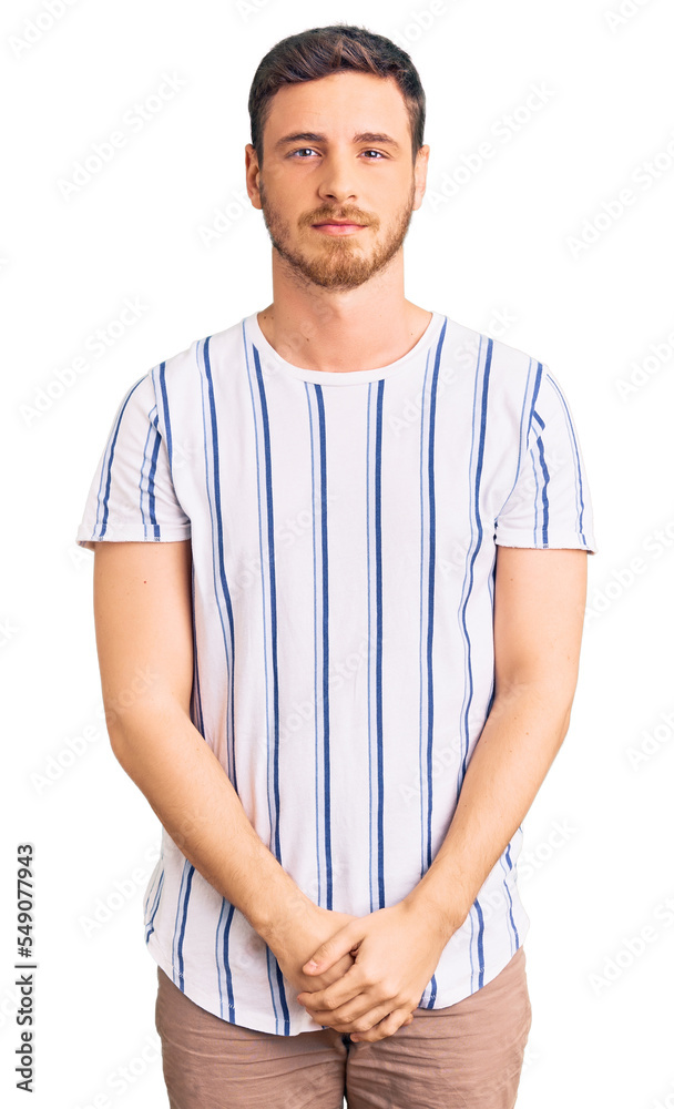 Handsome young man with bear wearing casual clothes with serious expression on face. simple and natural looking at the camera. Handsome young man with bear wearing casual clothes with serious expression on face. simple and natural looking at the camera.