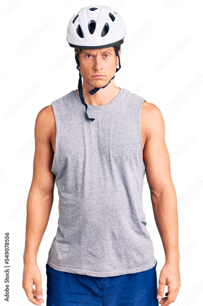 Young handsome man wearing bike helmet skeptic and nervous, frowning upset because of problem. negative person. Young handsome man wearing bike helmet skeptic and nervous, frowning upset because of problem. negative person.