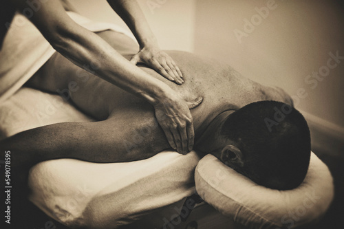 Grainy black and white art photo of bodywork massage therapy. 