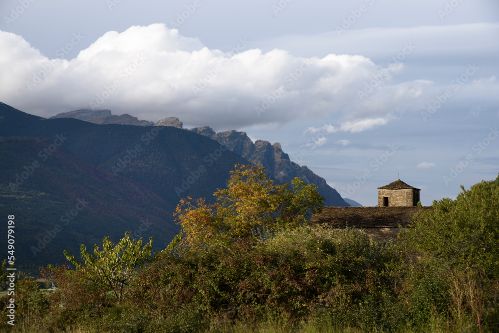 View of Romanesque church with background mountain and clouds View of Romanesque church with background mountain and clouds