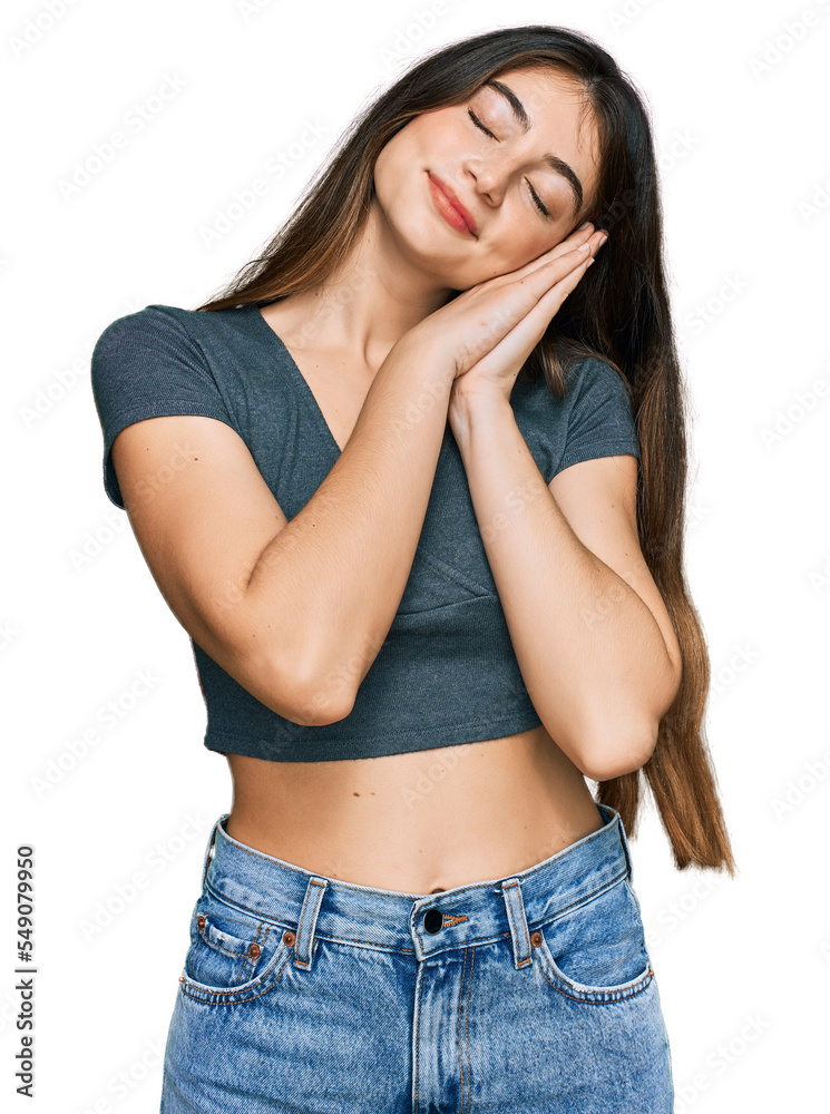 Young beautiful teen girl wearing casual crop top t shirt sleeping tired dreaming and posing with hands together while smiling with closed eyes.