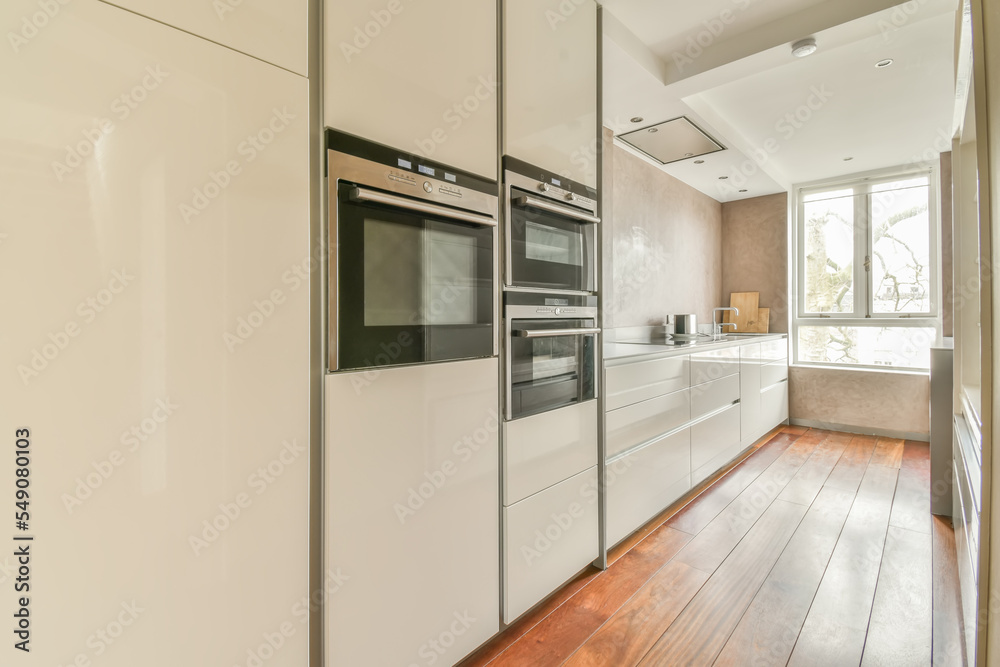 Interior of modern kitchen with white cabinets Interior of modern kitchen with white cabinets