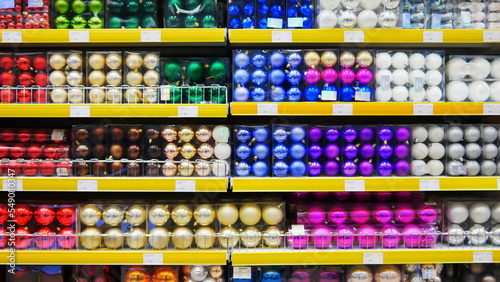 Many colorful Christmas balls on a store shelves