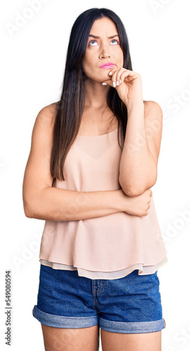 Young beautiful caucasian woman wearing casual clothes serious face thinking about question with hand on chin, thoughtful about confusing idea