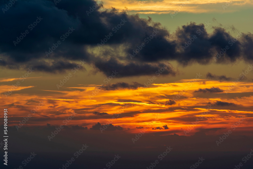 Dramatic colorful sunset sky with clouds over the sea