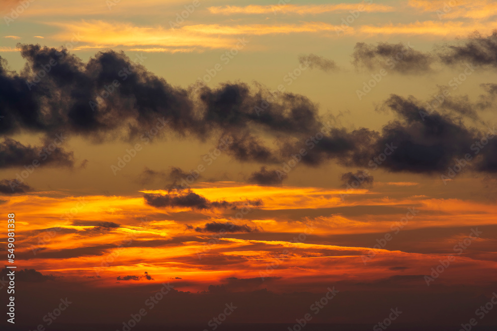 Dramatic colorful sunset sky with clouds over the sea