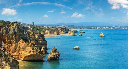 Ponta da Piedade (group of rock formations along coastline of Lagos town, Algarve, Portugal). People are unrecognizable.