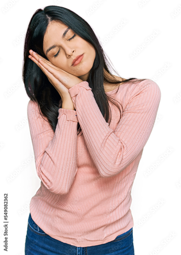 Young hispanic woman wearing casual clothes sleeping tired dreaming and posing with hands together while smiling with closed eyes. Young hispanic woman wearing casual clothes sleeping tired dreaming and posing with hands together while smiling with closed eyes.