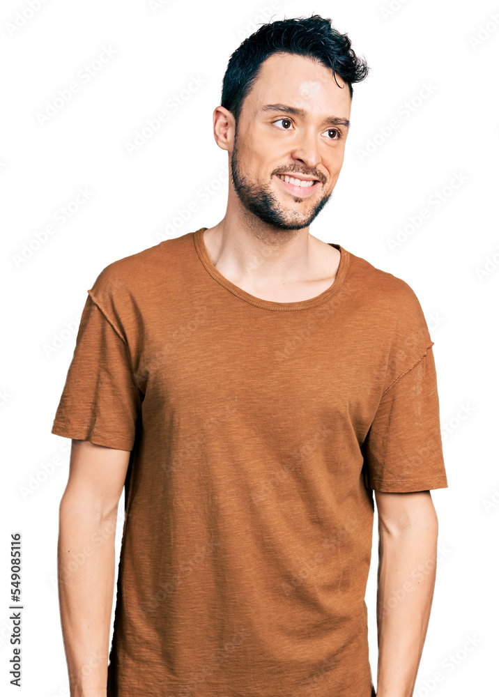 Hispanic man with beard wearing casual t shirt looking to side, relax profile pose with natural face and confident smile. Hispanic man with beard wearing casual t shirt looking to side, relax profile pose with natural face and confident smile.