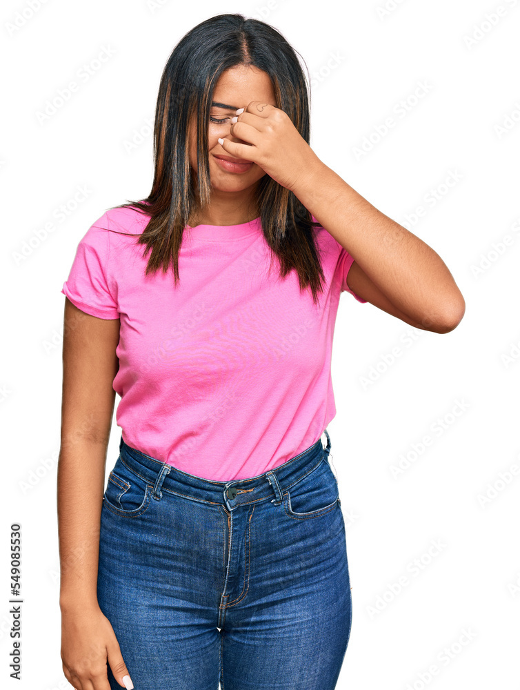 Young latin girl wearing casual clothes tired rubbing nose and eyes feeling fatigue and headache. stress and frustration concept. Young latin girl wearing casual clothes tired rubbing nose and eyes feeling fatigue and headache. stress and frustration concept.