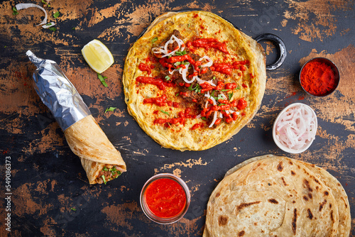 Beef Bhuna paratha roll kathi shawarma wrap with dipping sauce isolated on background side view of indian fastfood photo