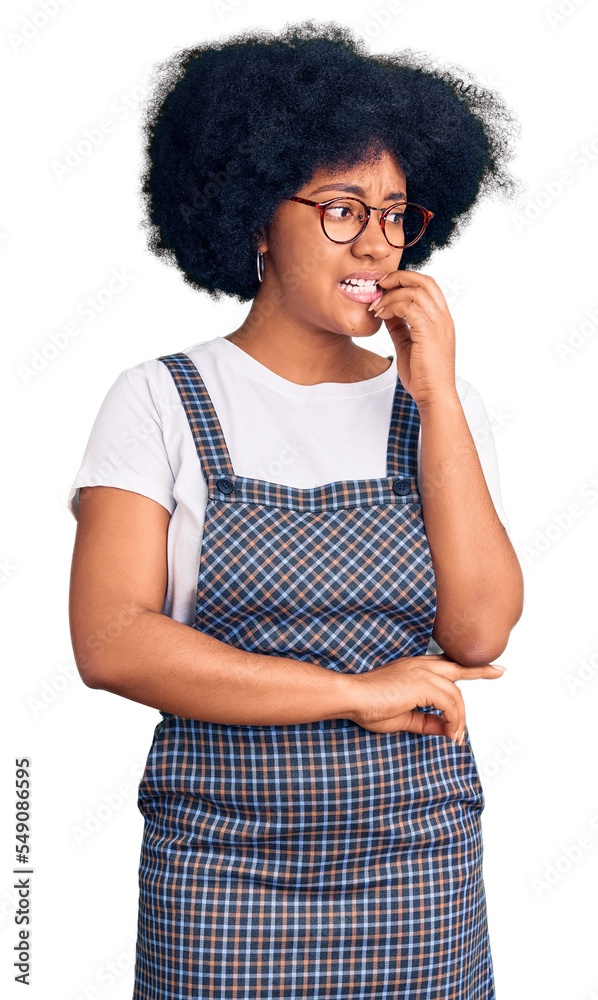 Young african american girl wearing casual clothes looking stressed and nervous with hands on mouth biting nails. anxiety problem. Young african american girl wearing casual clothes looking stressed and nervous with hands on mouth biting nails. anxiety problem.