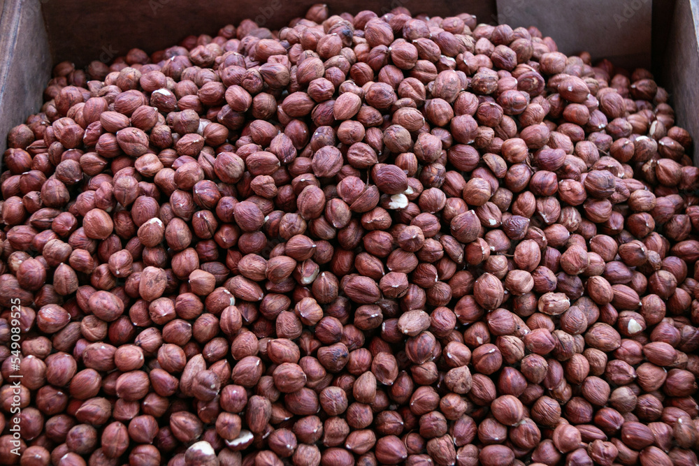 Background from hazelnut kernels. Close-up. Hazelnuts are used in the preparation of sweet dishes - chocolate, sweets, cakes, pastries. Background from hazelnut kernels. Close-up. Hazelnuts are used in the preparation of sweet dishes - chocolate, sweets, cakes, pastries.