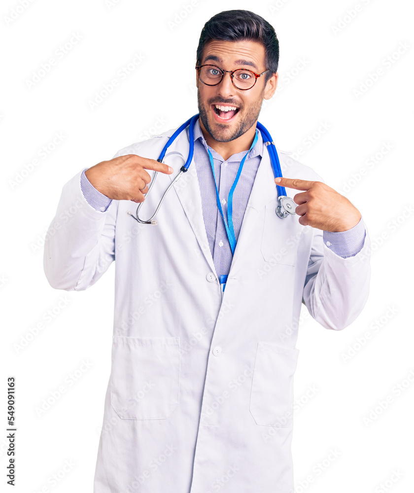 Young hispanic man wearing doctor uniform and stethoscope looking confident with smile on face, pointing oneself with fingers proud and happy.