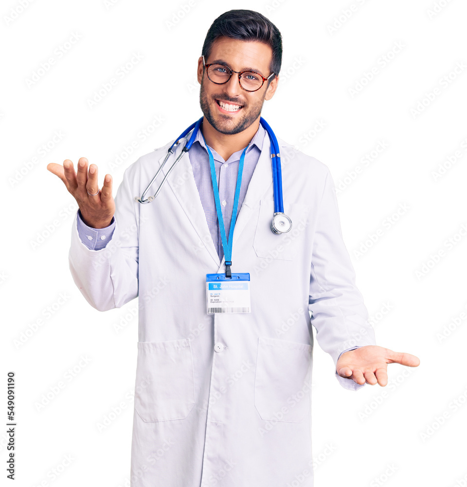 Young hispanic man wearing doctor uniform and stethoscope smiling cheerful with open arms as friendly welcome, positive and confident greetings Young hispanic man wearing doctor uniform and stethoscope smiling cheerful with open arms as friendly welcome, positive and confident greetings