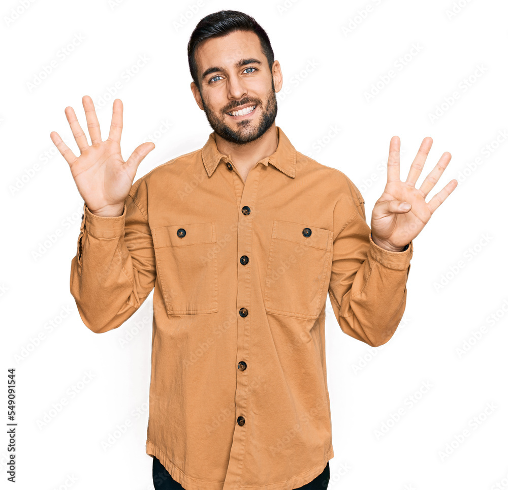 Young hispanic man wearing casual clothes showing and pointing up with fingers number nine while smiling confident and happy. Young hispanic man wearing casual clothes showing and pointing up with fingers number nine while smiling confident and happy.