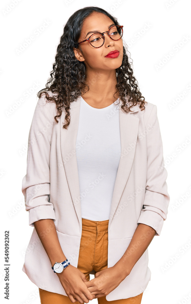 Young african american girl wearing business clothes smiling looking to the side and staring away thinking. Young african american girl wearing business clothes smiling looking to the side and staring away thinking.