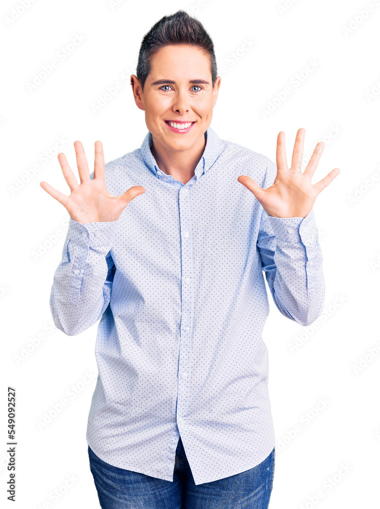 Young woman with short hair wearing business clothes showing and pointing up with fingers number ten while smiling confident and happy. Young woman with short hair wearing business clothes showing and pointing up with fingers number ten while smiling confident and happy.