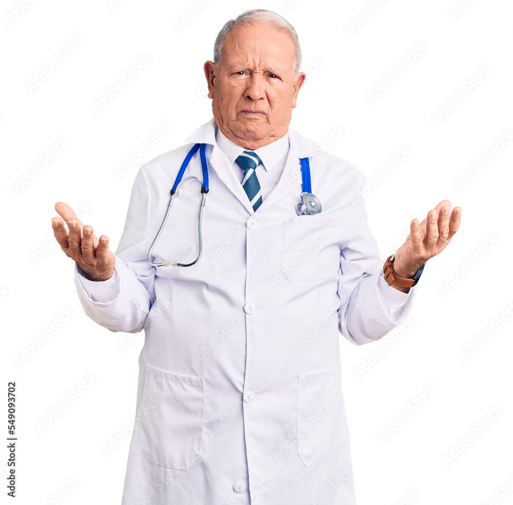 Senior handsome grey-haired man wearing doctor coat and stethoscope clueless and confused with open arms, no idea concept. Senior handsome grey-haired man wearing doctor coat and stethoscope clueless and confused with open arms, no idea concept.