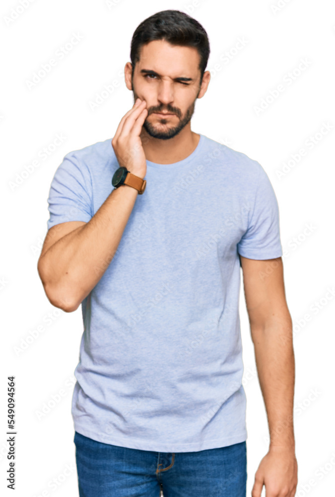 Young hispanic man wearing casual clothes touching mouth with hand with painful expression because of toothache or dental illness on teeth. dentist Young hispanic man wearing casual clothes touching mouth with hand with painful expression because of toothache or dental illness on teeth. dentist
