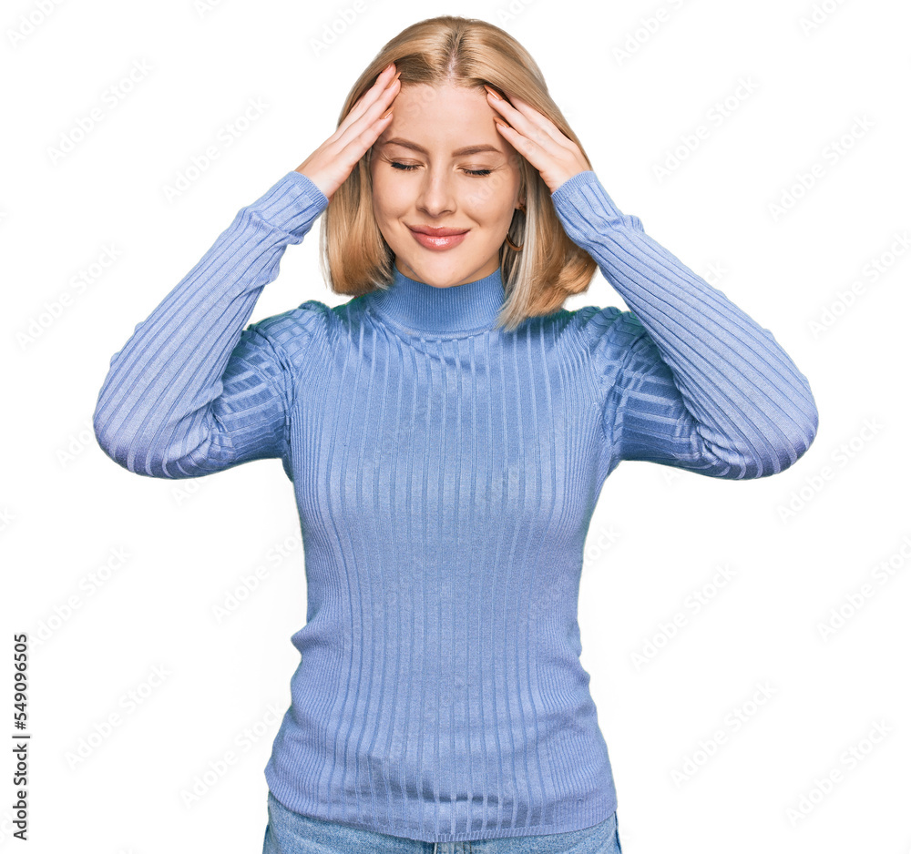 Young blonde woman wearing casual clothes suffering from headache desperate and stressed because pain and migraine. hands on head. Young blonde woman wearing casual clothes suffering from headache desperate and stressed because pain and migraine. hands on head.