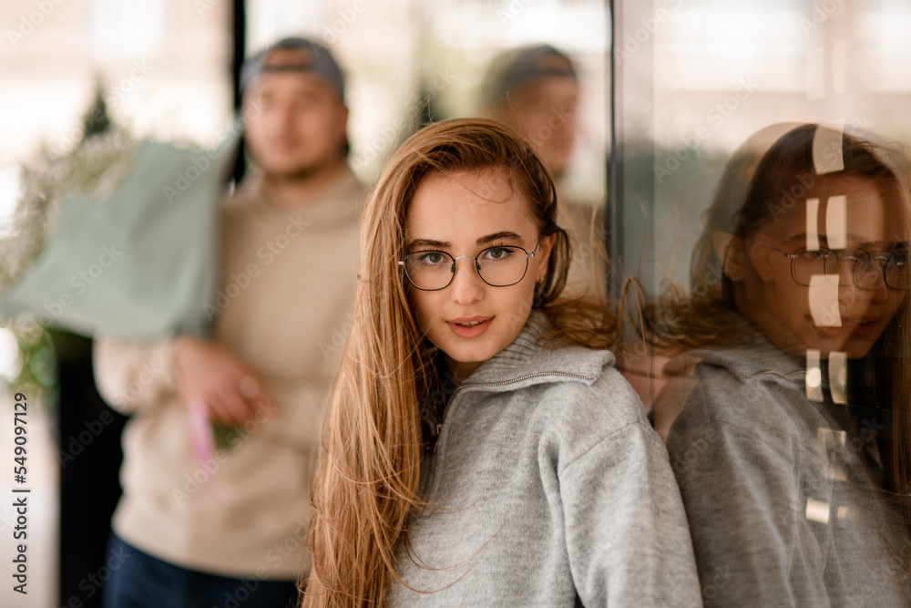 portrait of beautiful woman in glasses with long brown hair. Blurred background portrait of beautiful woman in glasses with long brown hair. Blurred background