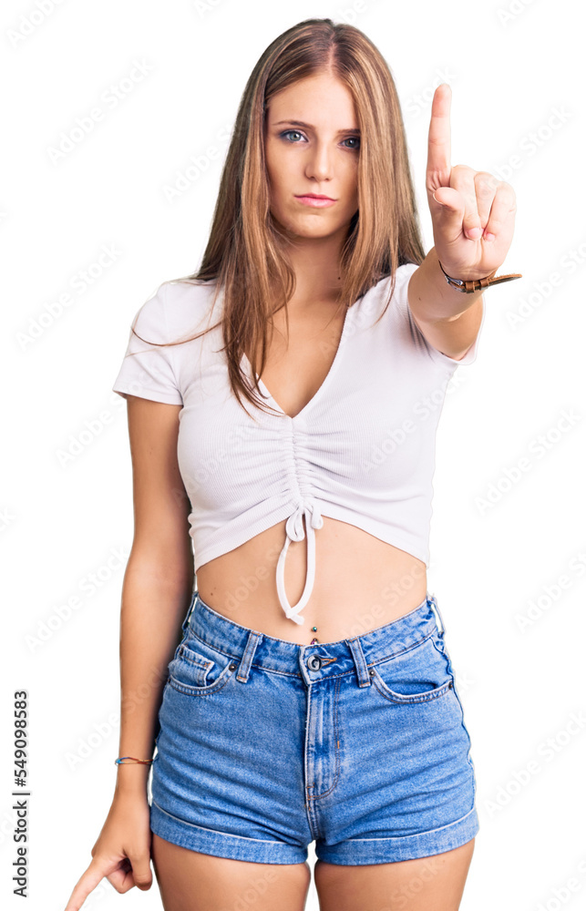 Young beautiful blonde woman wearing casual white tshirt pointing with finger up and angry expression, showing no gesture Young beautiful blonde woman wearing casual white tshirt pointing with finger up and angry expression, showing no gesture
