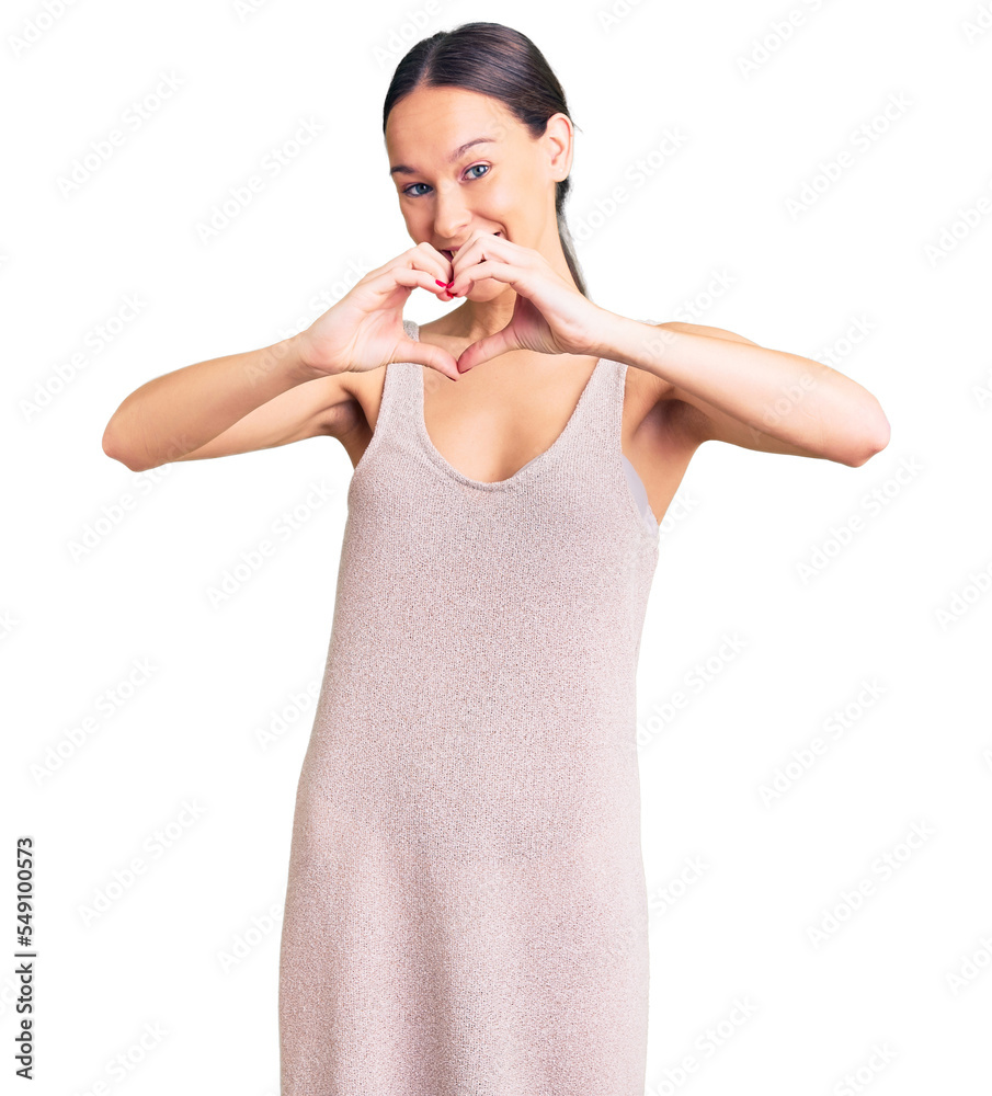 Beautiful brunette young woman wearing casual dress smiling in love showing heart symbol and shape with hands. romantic concept. Beautiful brunette young woman wearing casual dress smiling in love showing heart symbol and shape with hands. romantic concept.
