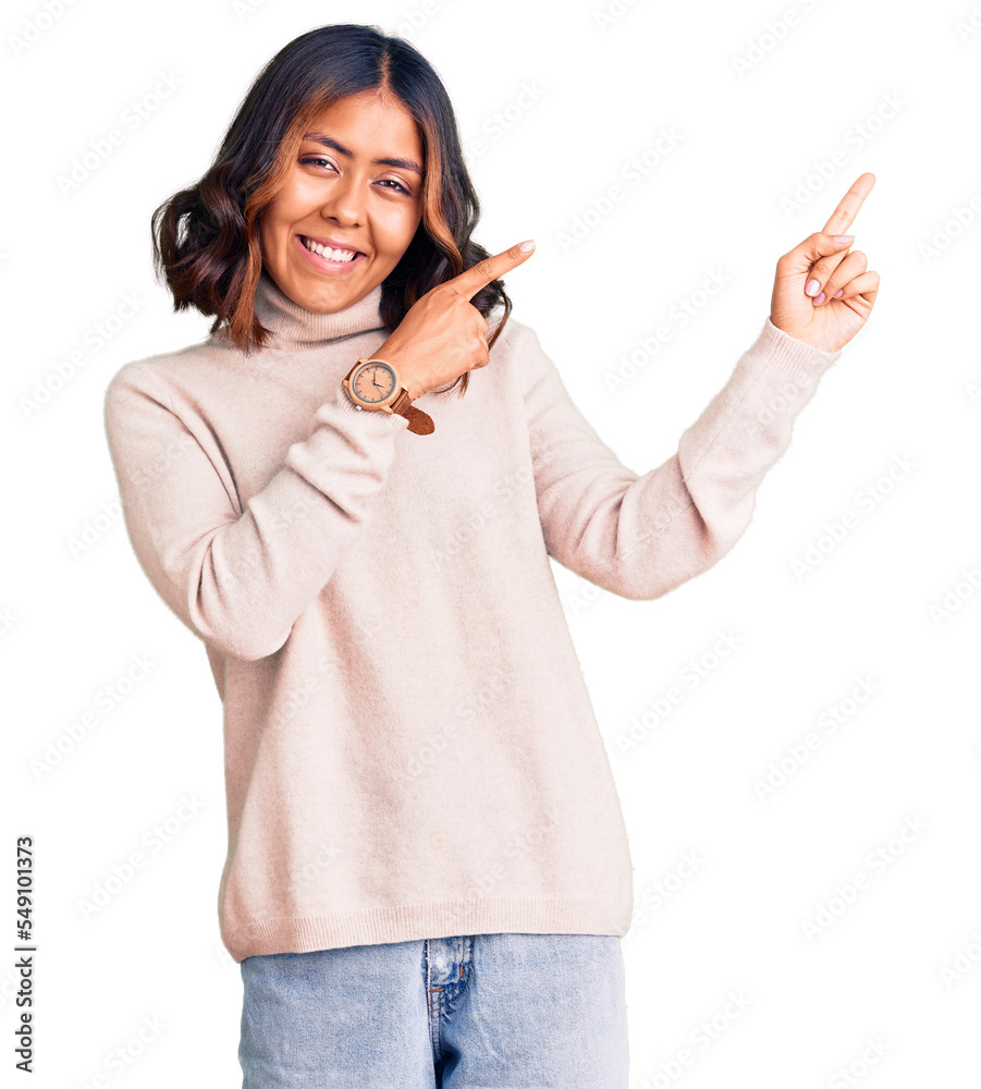 Young beautiful mixed race woman wearing winter turtleneck sweater smiling and looking at the camera pointing with two hands and fingers to the side. Young beautiful mixed race woman wearing winter turtleneck sweater smiling and looking at the camera pointing with two hands and fingers to the side.