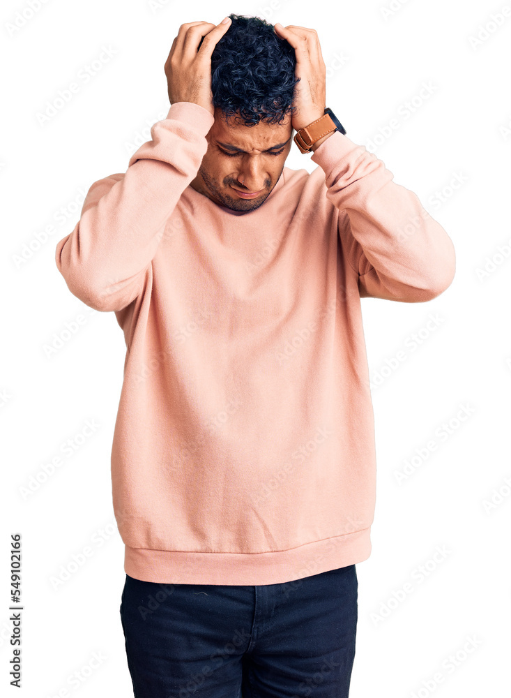 Young hispanic man wearing casual clothes suffering from headache desperate and stressed because pain and migraine. hands on head. Young hispanic man wearing casual clothes suffering from headache desperate and stressed because pain and migraine. hands on head.