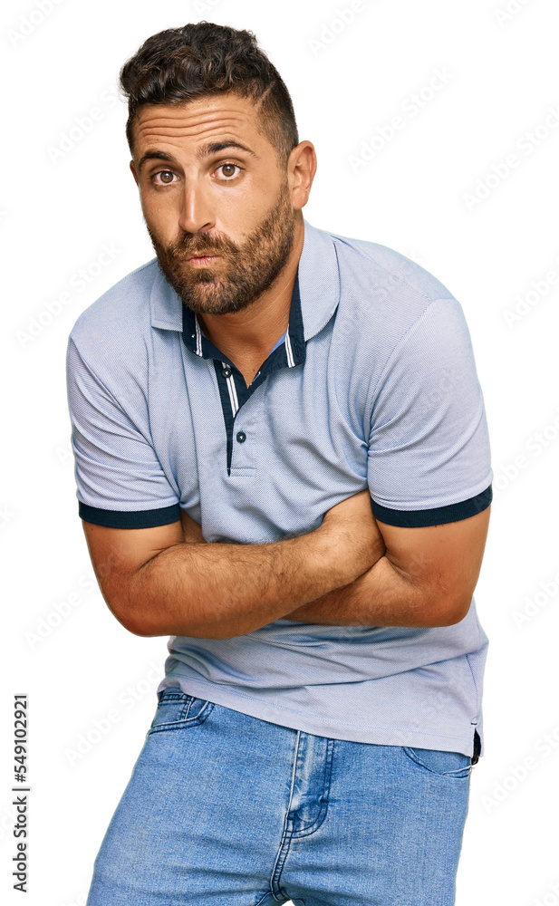 Handsome man with beard wearing casual clothes shaking and freezing for winter cold with sad and shock expression on face Handsome man with beard wearing casual clothes shaking and freezing for winter cold with sad and shock expression on face